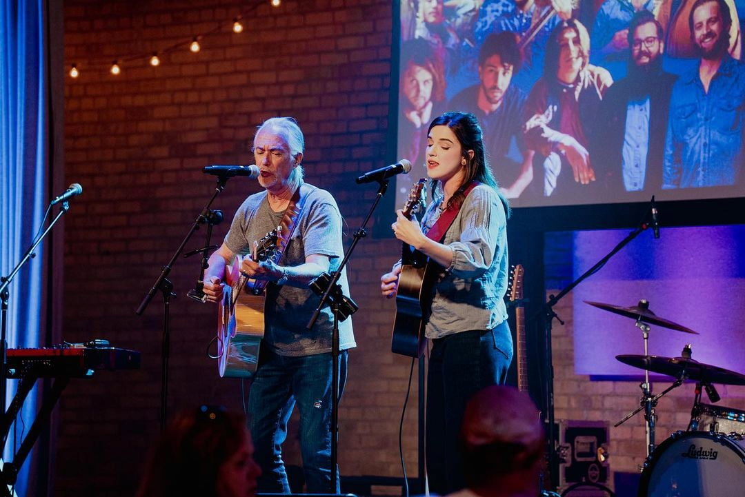 John and Cass performing on stage together